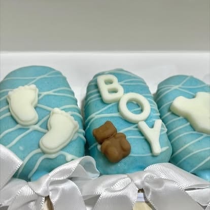 Blue boy cakesicles with teddy bear and footprint decorations