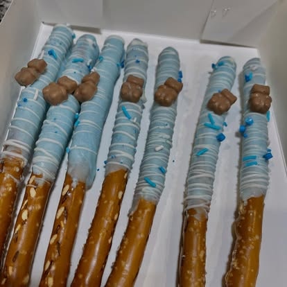 Baby shower pretzel treats with blue sprinkles and teddy bear toppers