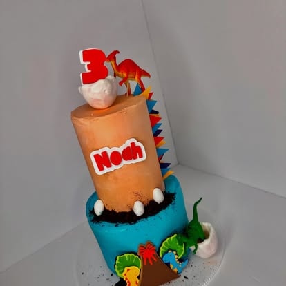 Colorful stacked dinosaur birthday cake