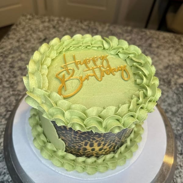 Green leopard print birthday cake with gold Happy Birthday topper