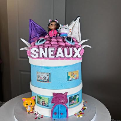 Gabby Dollhouse themed birthday cake with character decorations