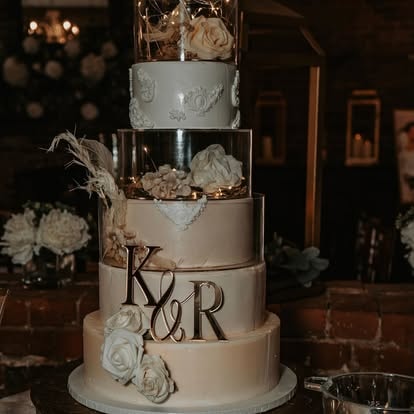 Four tier K&R wedding cake with gold acrylic letters and floral accents